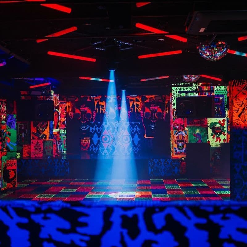 Deluxx Fluxx NYC art installation nightclub interior with arcade cabinets and colorful lighting