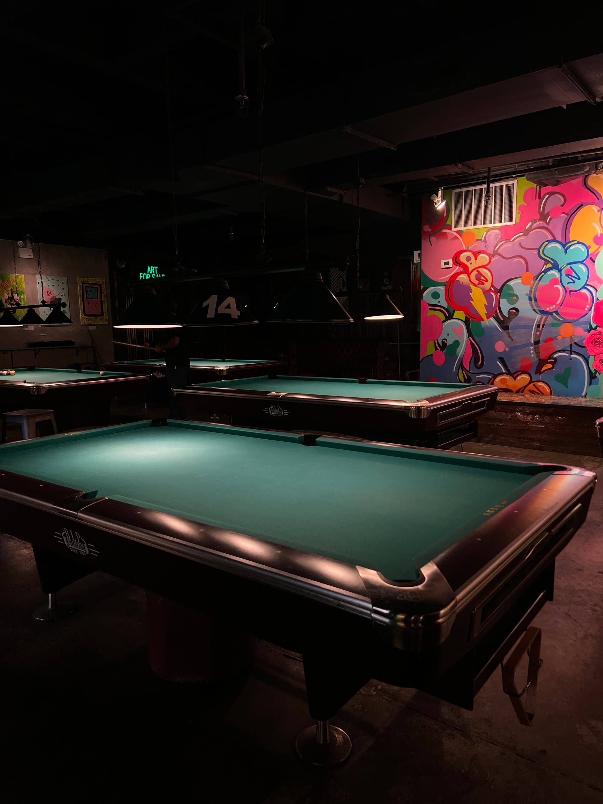 Game hall interior with pool tables and local art at Sour Mouse on Delancey Street, Lower East Side