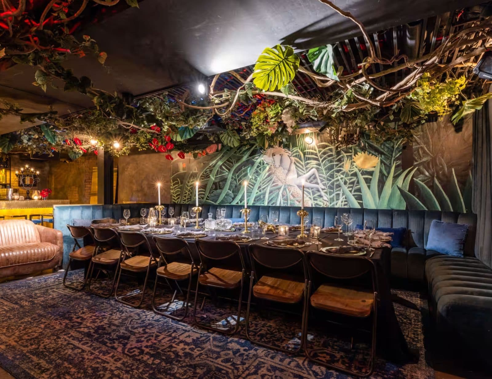 LOULOU Chelsea speakeasy interior with a gold bar and velvet seating