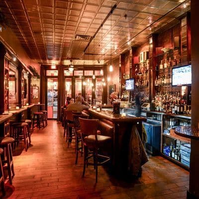 Exposed brick bar area with warm lighting at Velvet Brooklyn in Williamsburg