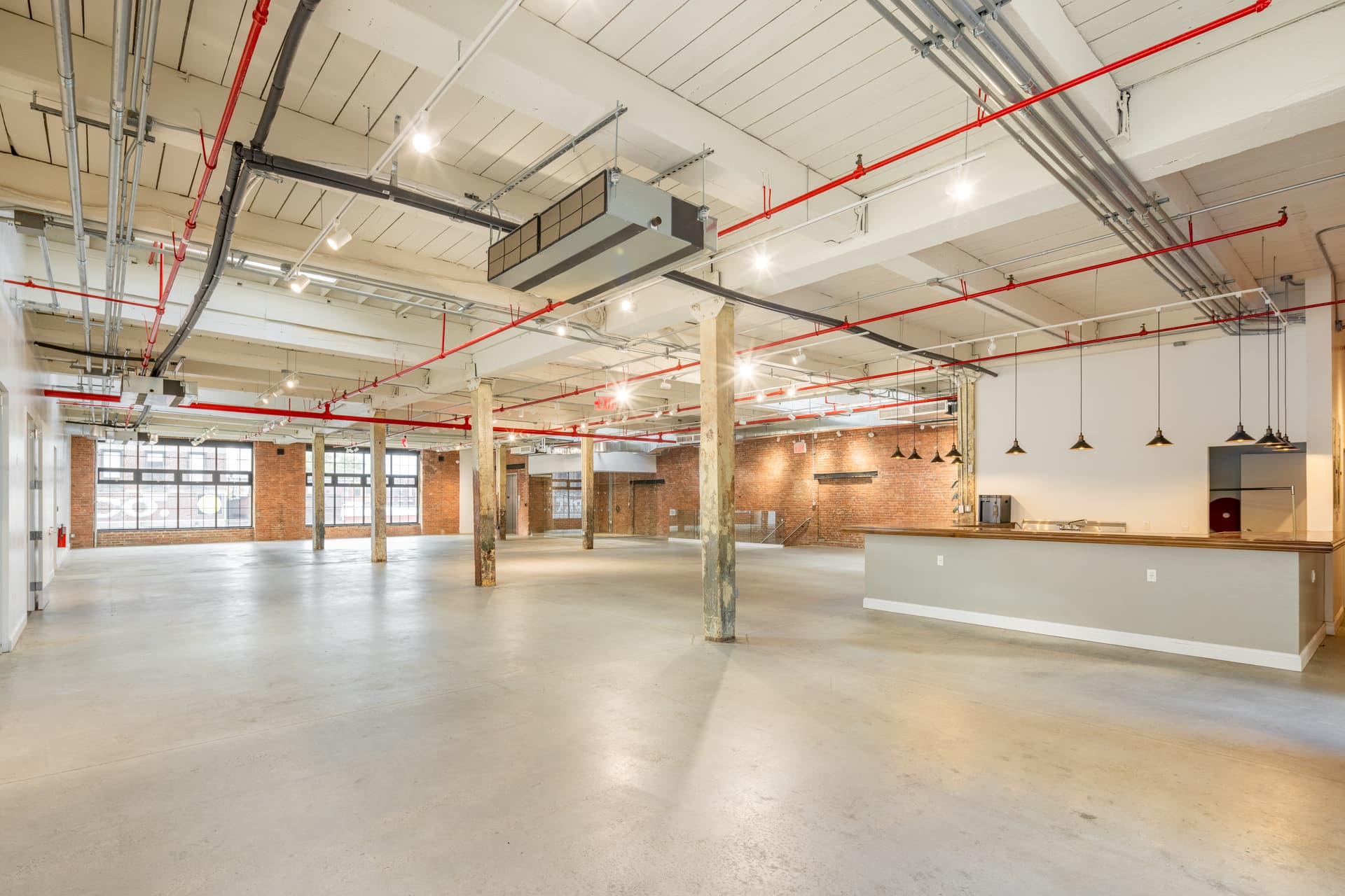Industrial main hall with exposed brick and skylights at 100 Sutton in Greenpoint