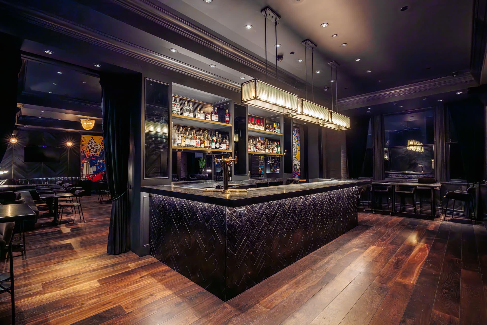 Lot 15 cocktail lounge inside Kixby Hotel Midtown Manhattan private event space with dark art-accented interior