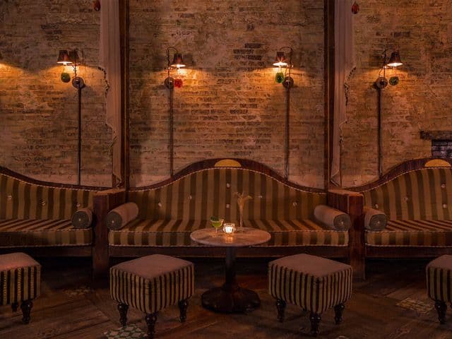 Candlelit interior of Apotheke cocktail bar in Chinatown