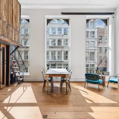 Sunlit loft interior with rustic furnishings at The Farm SoHo on Broadway