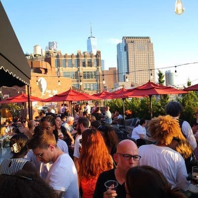 Outdoor terrace at ART SoHo rooftop bar with downtown Manhattan skyline views