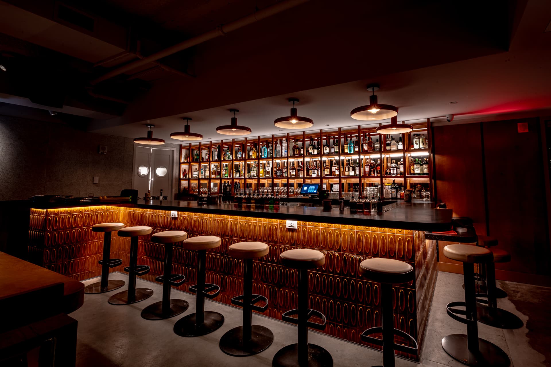 Retro lounge interior at Seed Library NYC with low lighting and vintage-styled seating