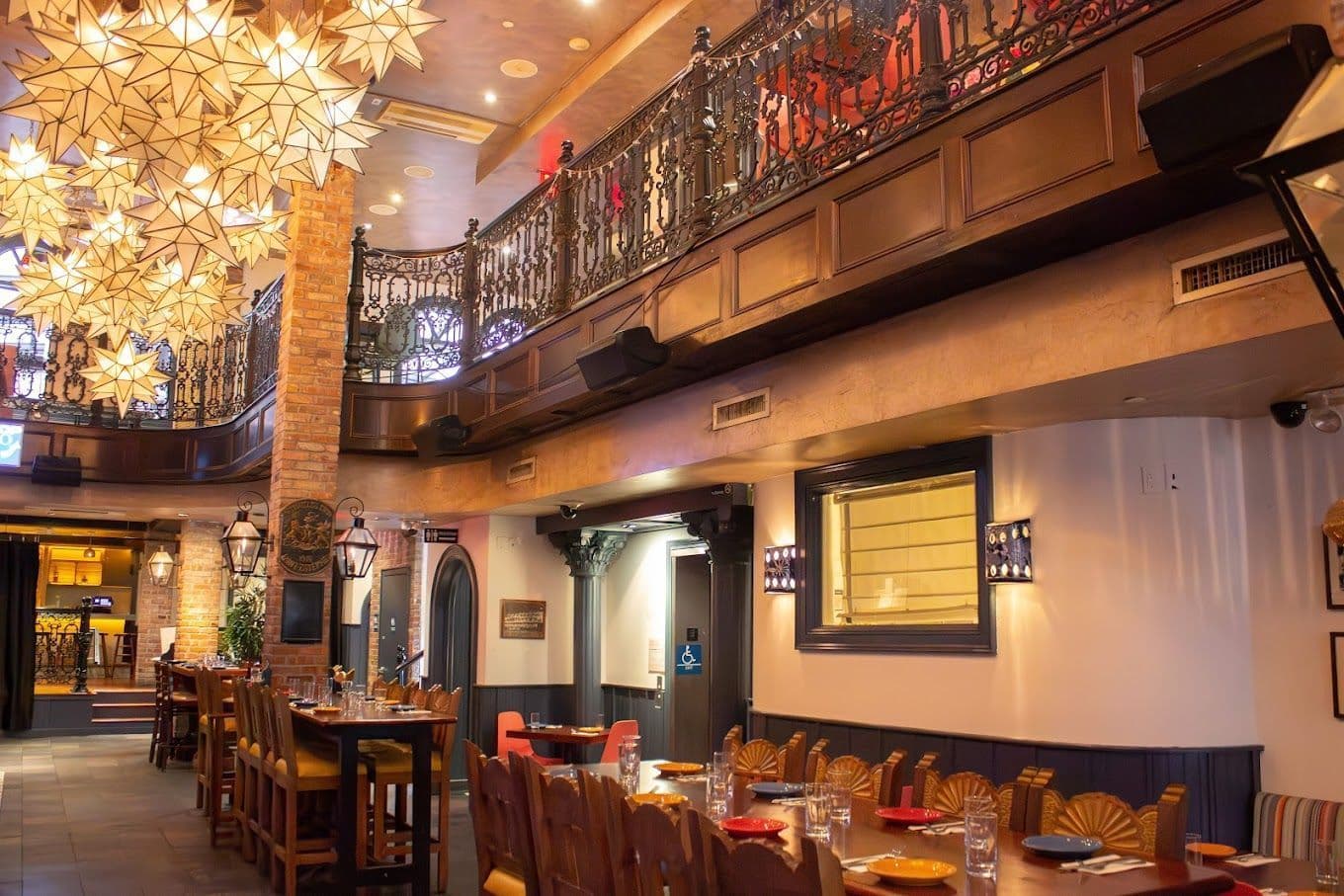 Interior of Backstage Tavern on Restaurant Row with its wood-carved bar and high ceilings
