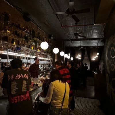 Upstairs bar area at Little More in Tribeca with the marble bar and spirits library