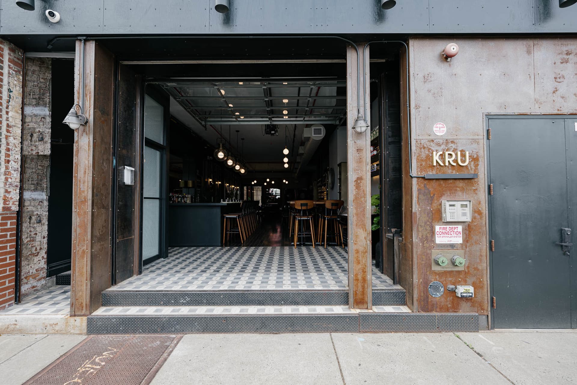 Industrial-chic dining room with exposed brick at KRU Brooklyn in Williamsburg