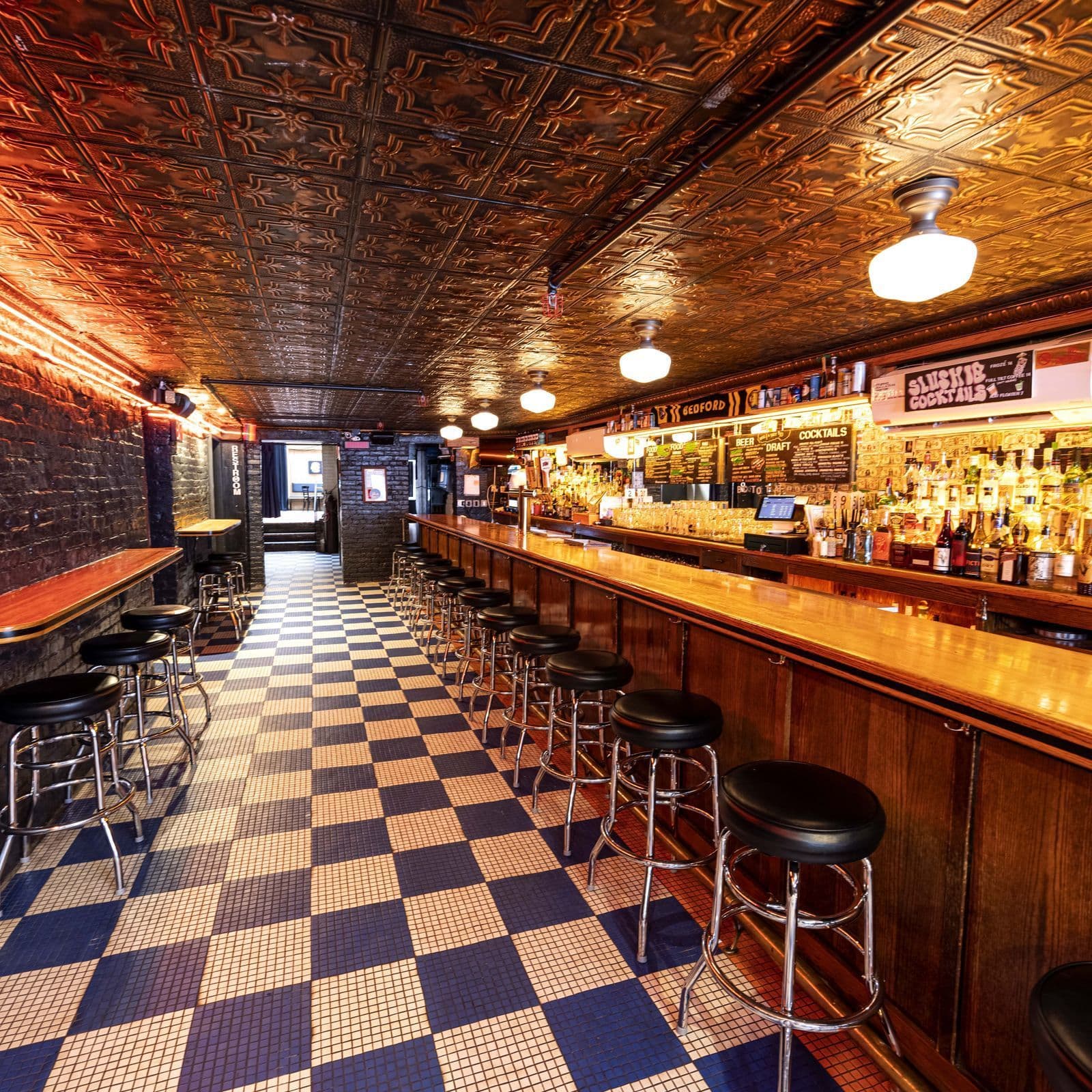 Classic dive bar interior with checkered floor at Pubkey in Greenwich Village
