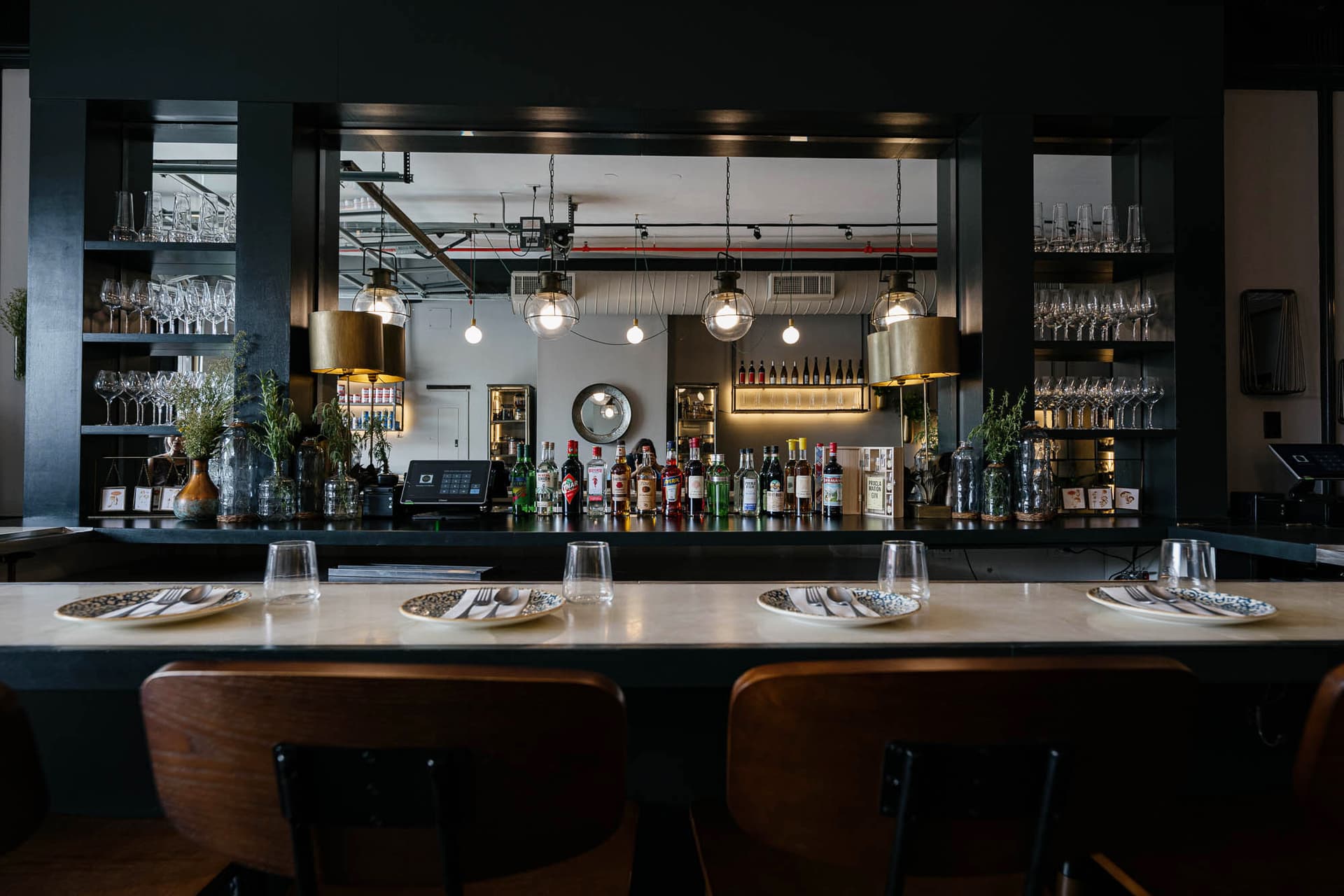 Industrial dining room with exposed brick and track lighting at KRU Brooklyn in Williamsburg