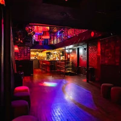 Mehanata Bulgarian Bar's red-lit multi-level interior on the Lower East Side