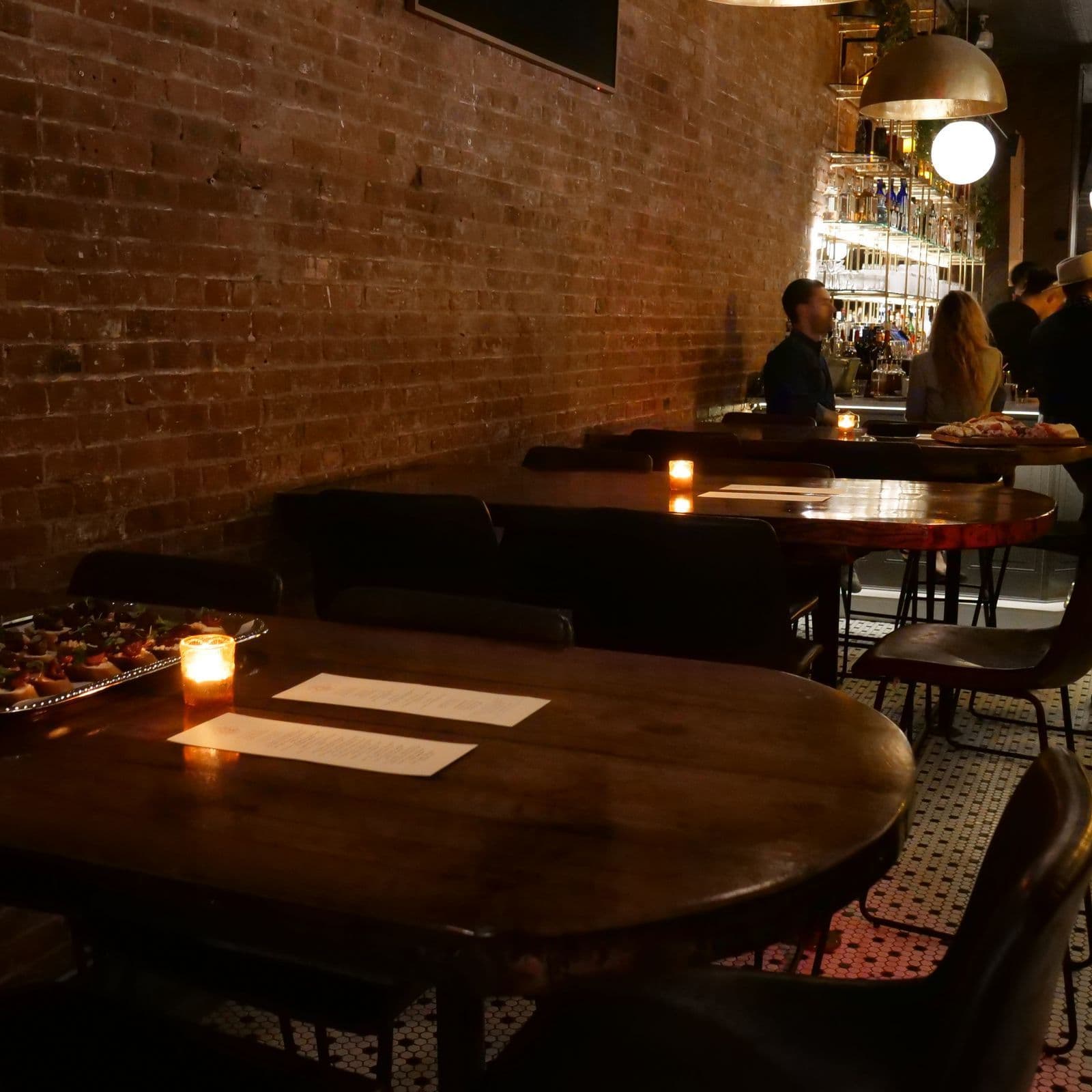 Upstairs dining area and marble bar at Little More in Tribeca