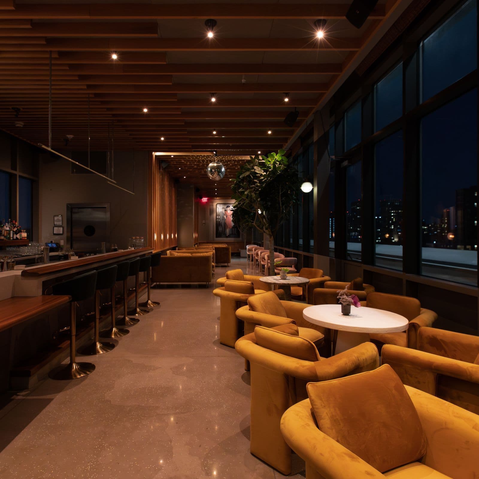 Lounge interior with downtown skyline views at Unlisted above Freeman Alley