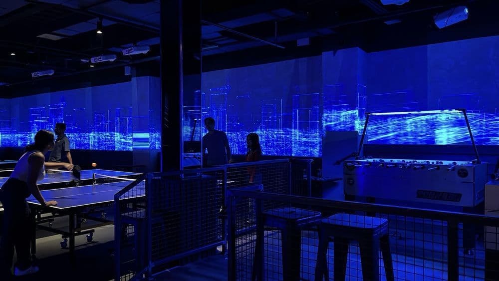 Projection-mapped walls and game area inside Sugar Mouse in the East Village