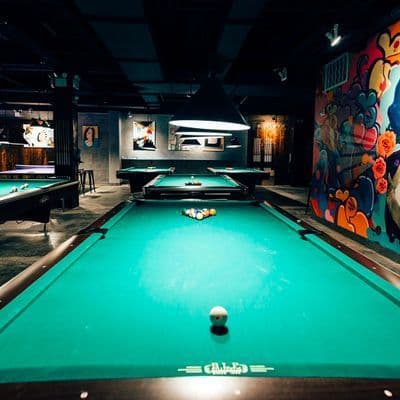Pool tables and local art inside Sour Mouse game hall on the Lower East Side