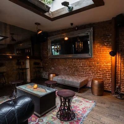 Cozy nautical-themed bar and dining space at The Folly on West Houston Street