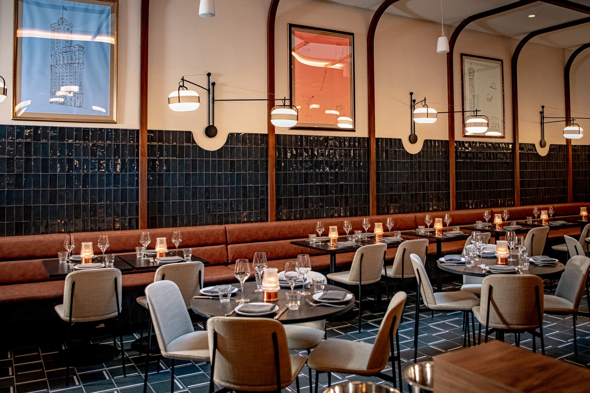 Warm tavern-style dining room at The Alderman with walnut millwork and banquette seating