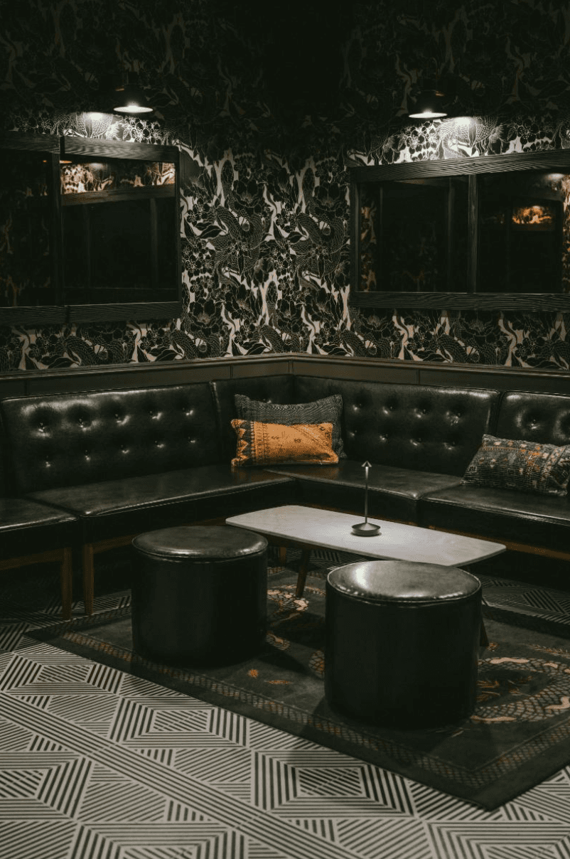 The downstairs speakeasy at Little More in Tribeca with dim lighting and lounge seating